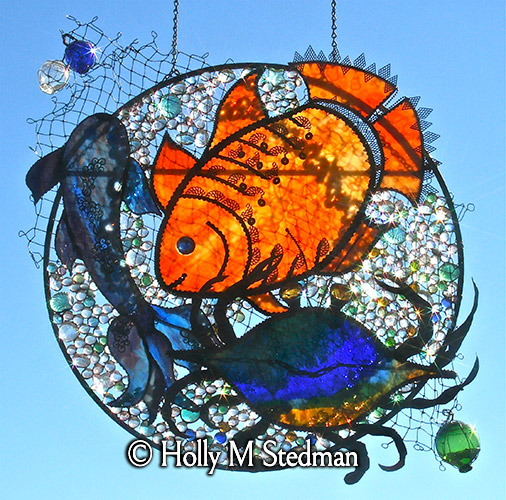 Circular stained glass panel with sea creatures