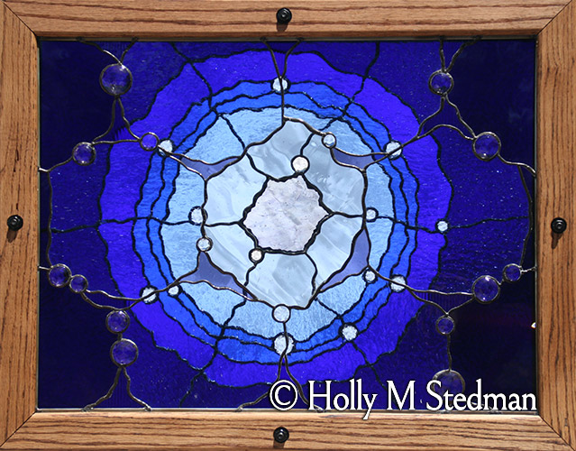 Framed, multilevel stained glass panel with transparent abstract flower design