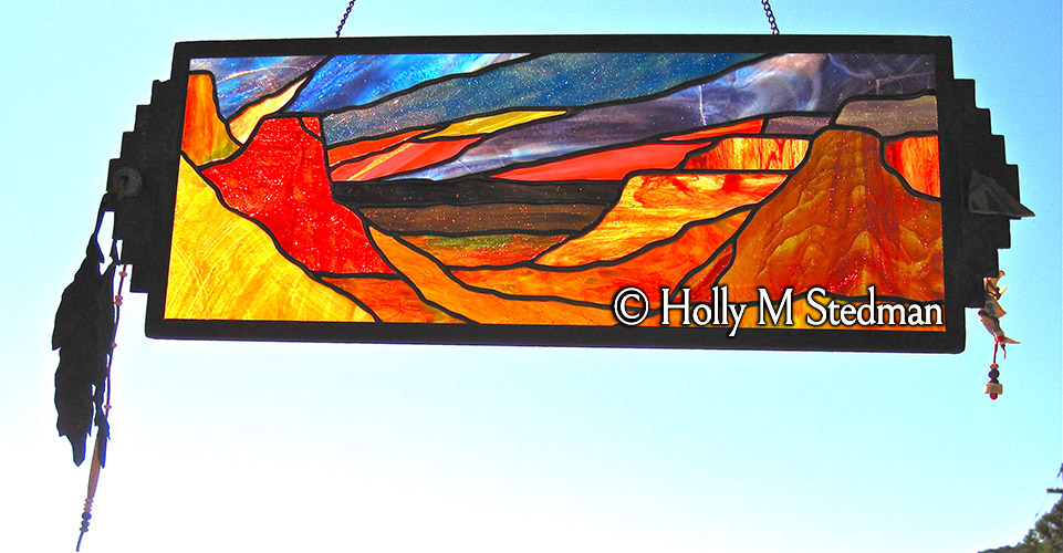 Framed stained glass panel of the Grand Canyon with feathers