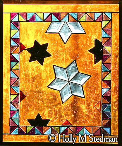 Stained glass panel with stars and geometric border