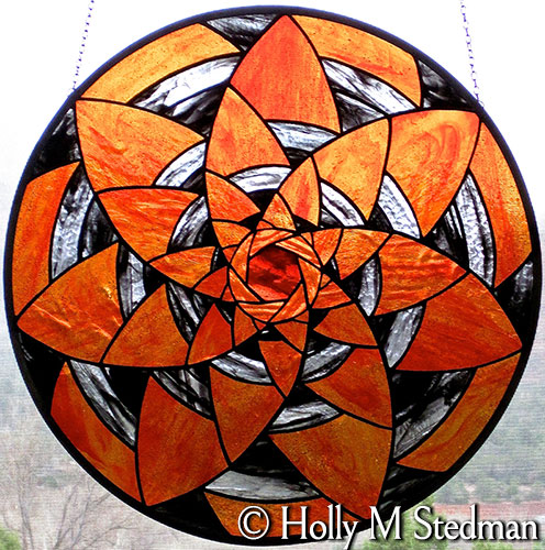 Circular stained glass panel with spiral design