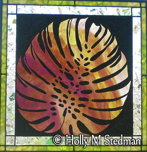 Stained glass panel with an imprint of an exotic leaf