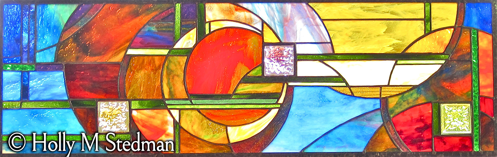 Stained glass window with colorful circular design