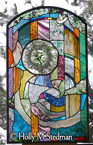 Short stained glass window with flowing and colorful abstract pattern
