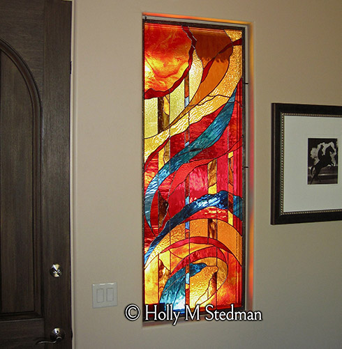 Colorful stained glass window beside a door