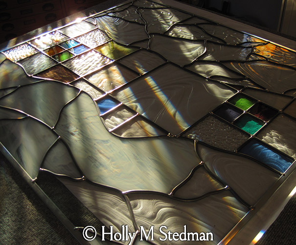 Stained glass window laying on a table