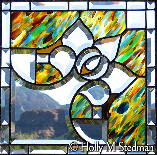 Bevelled stained glass panel with green, yellow and orange highlights