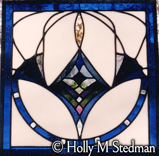 Stained glass panel with white and blue abstract geometric pattern