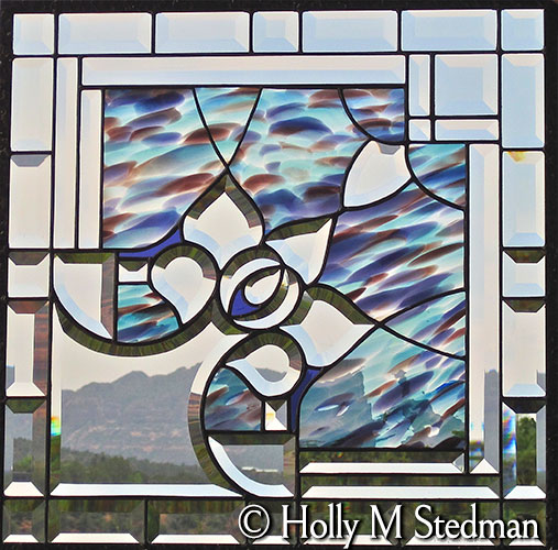 Bevelled stained glass panel with blue and purple highlights