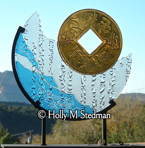 Stained glass sculpture with asian coin