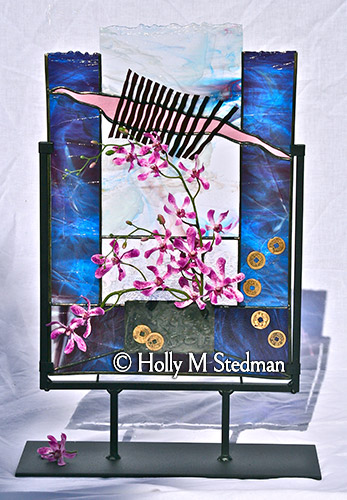 Stained glass sculpture with asian theme and blue highlights with pink flowers