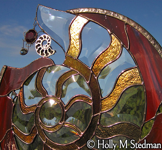 Detail of nautilus sculpture: bands of gold glass on the shell pattern