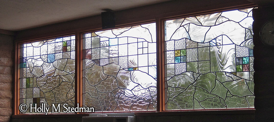 Three-piece stained glass window with transparent design